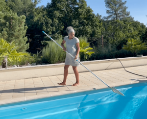 Woman Cleaning a Pool